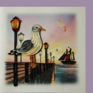 Quilled seagull on lamplit pier at sunset
